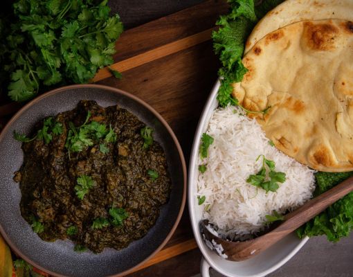 Delicious Indian spinach curry served with rice and naan bread.